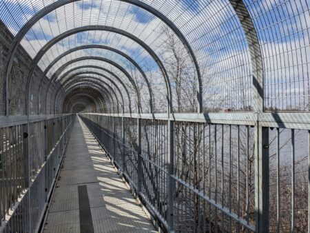 covered walkway next to road bridge